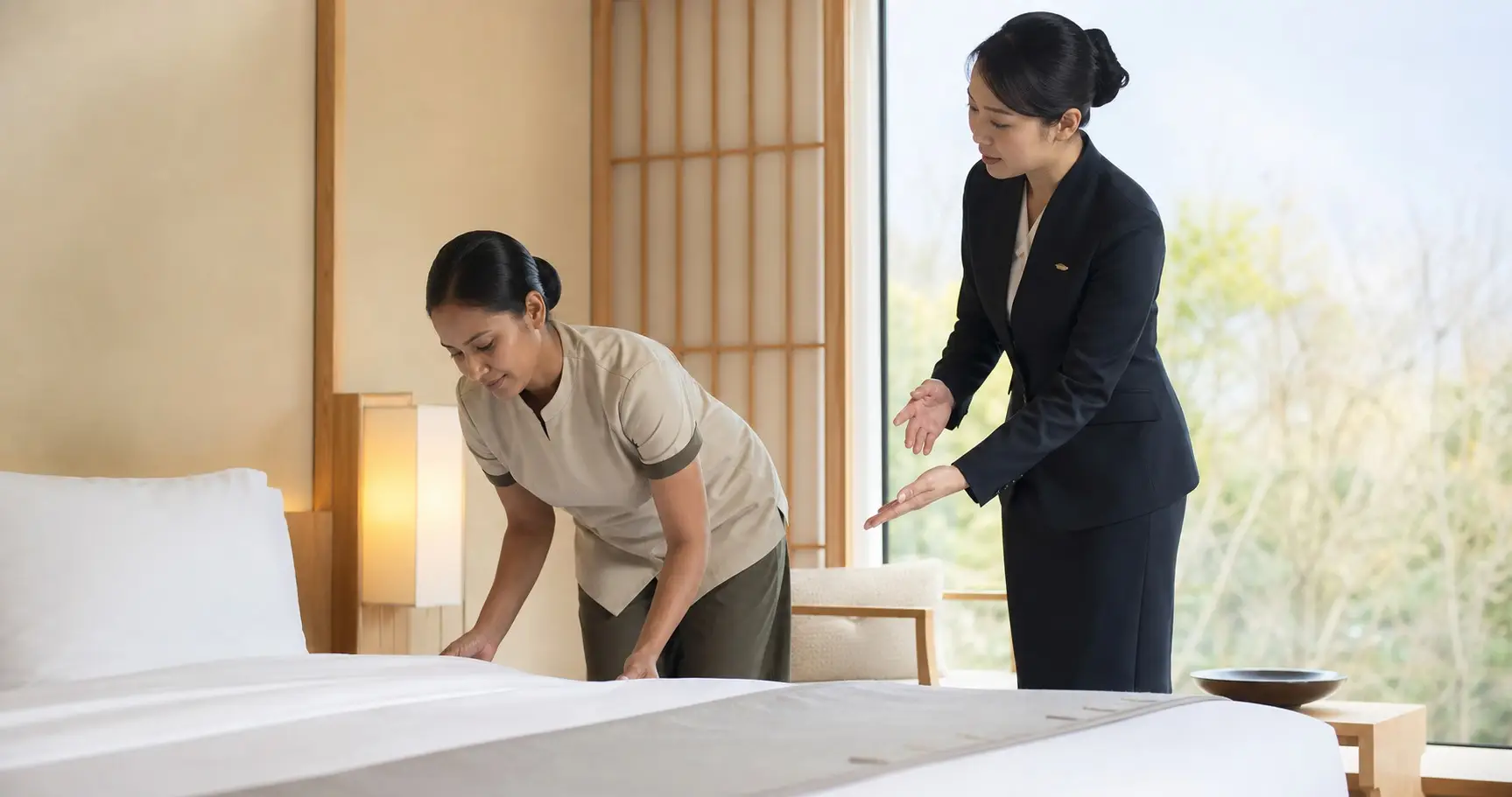 Sri Lankan accommodation worker receiving room preparation guidance